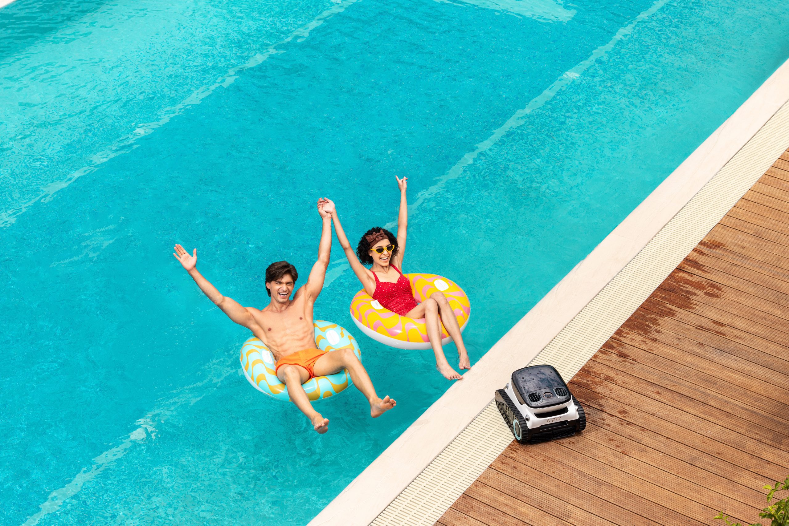 A couple is swimming in a rectangular pool