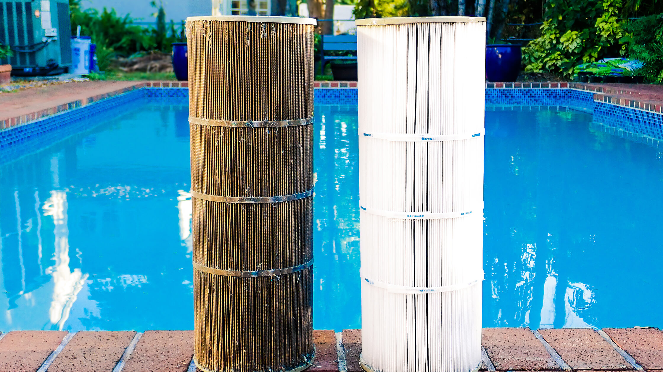 Comparison of a dirty pool filter and a clean pool filter side by side in front of a swimming pool.