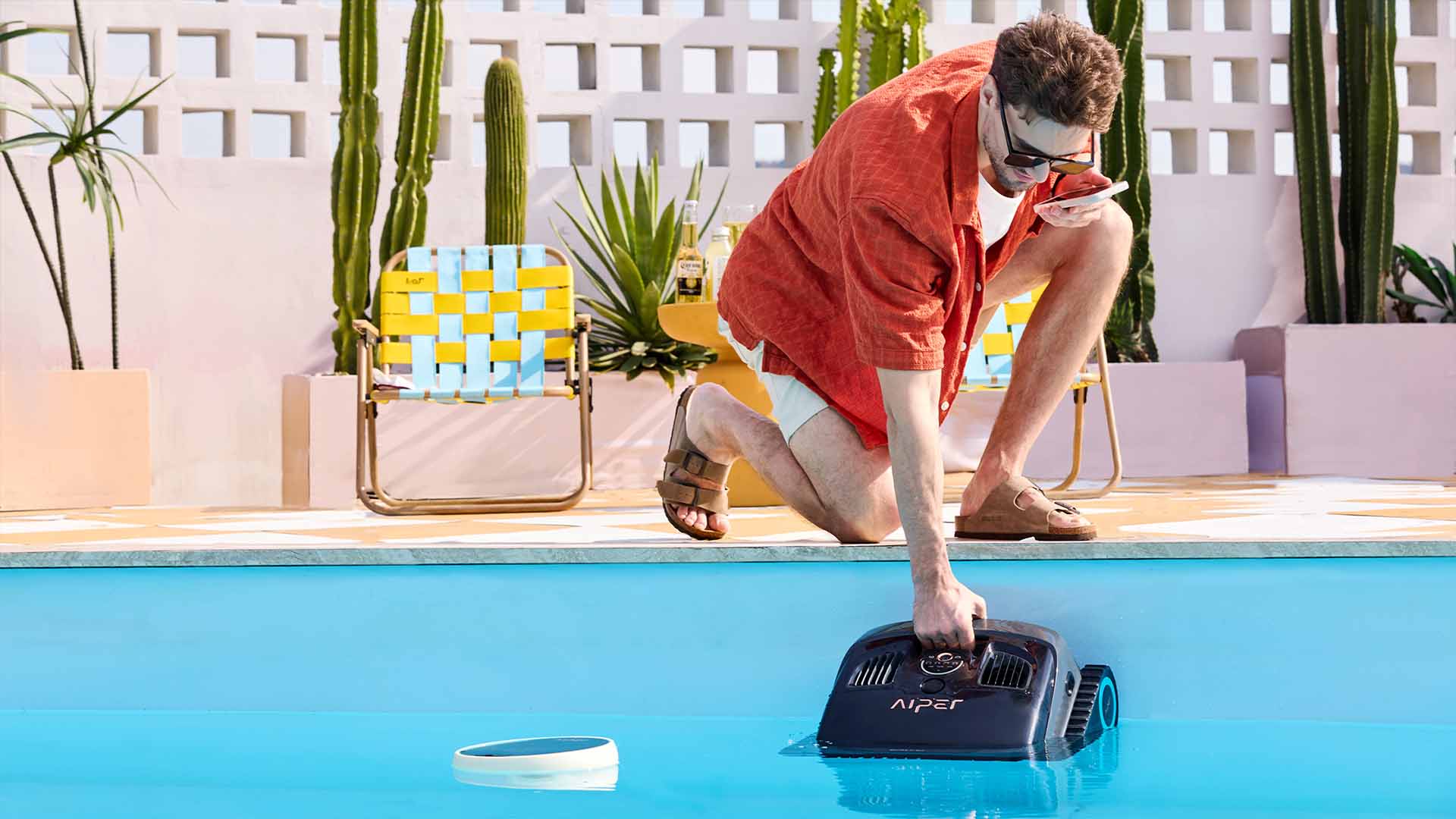 The robotic pool cleaner is parked poolside for easy access.