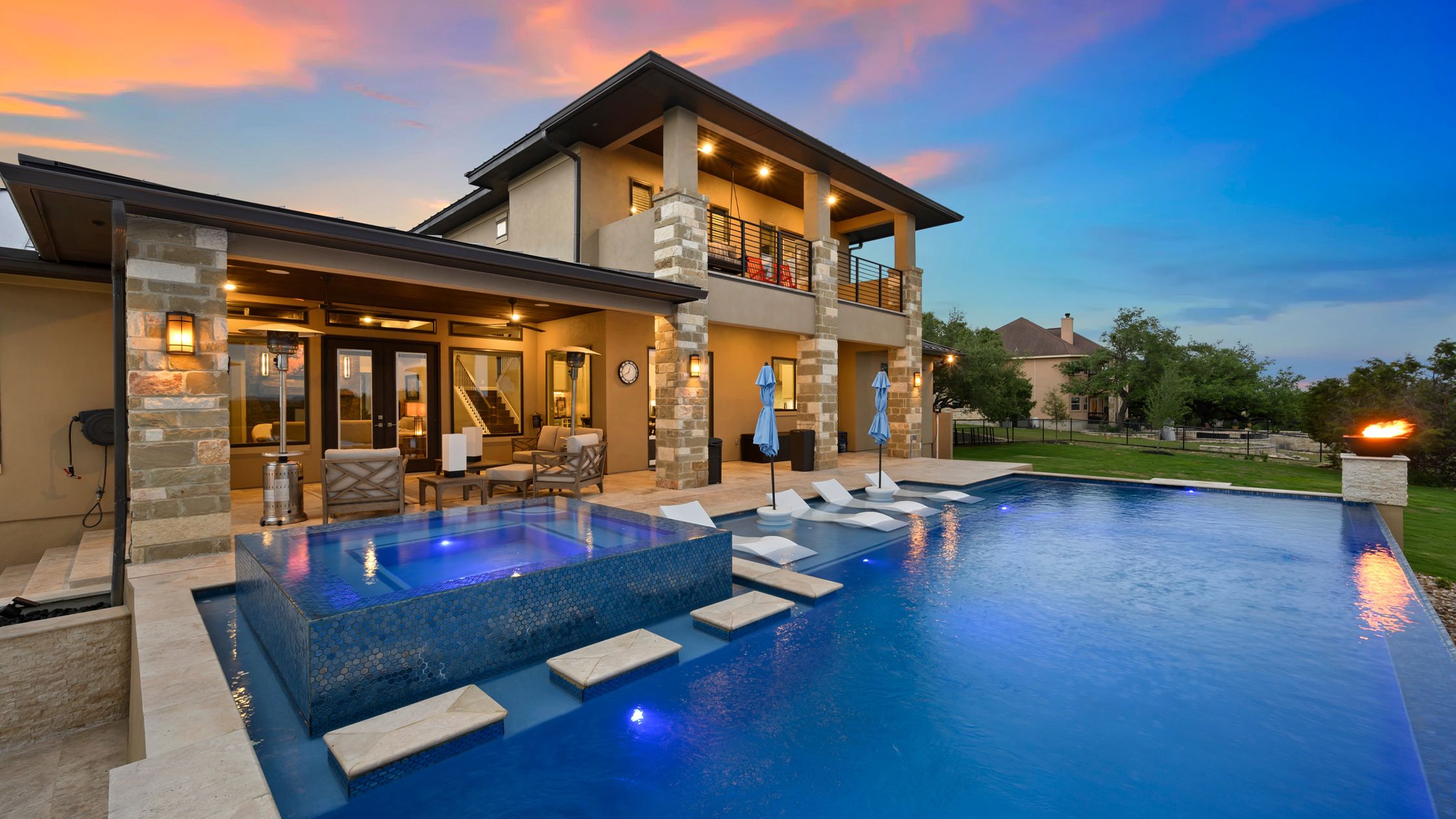 Luxury hotel pool at sunset with modern design and comfortable seating