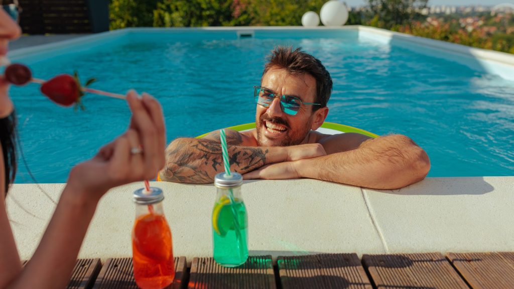 People enjoy refreshment by the pool deck.