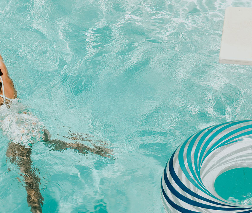 A girl swims in a clear pool after the shock